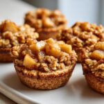 Close-up of several delicious Apple Crisp Cookie Cups topped with cinnamon-spiced apples and oat crumble.