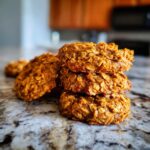 A stack of delicious Cinnamon Sweet Potato Breakfast Cookies on a marble countertop.